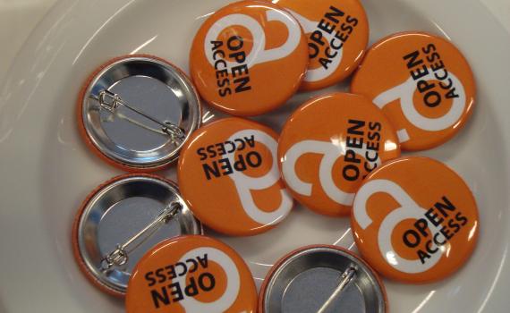 A group of open access lapel buttons.