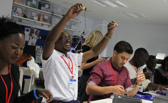 Young African public library innovators using tools during a hands-on experience in the National Library of Lithuania makerspace.