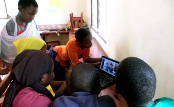 Deaf children chat to friends in Canada using Skype.